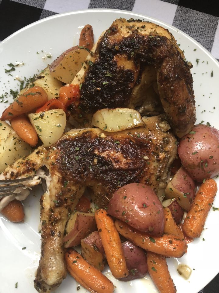 a white plate topped with chicken, potatoes and carrots