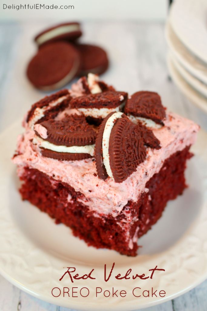 a red velvet oreo poke cake on a white plate with cookies in the background