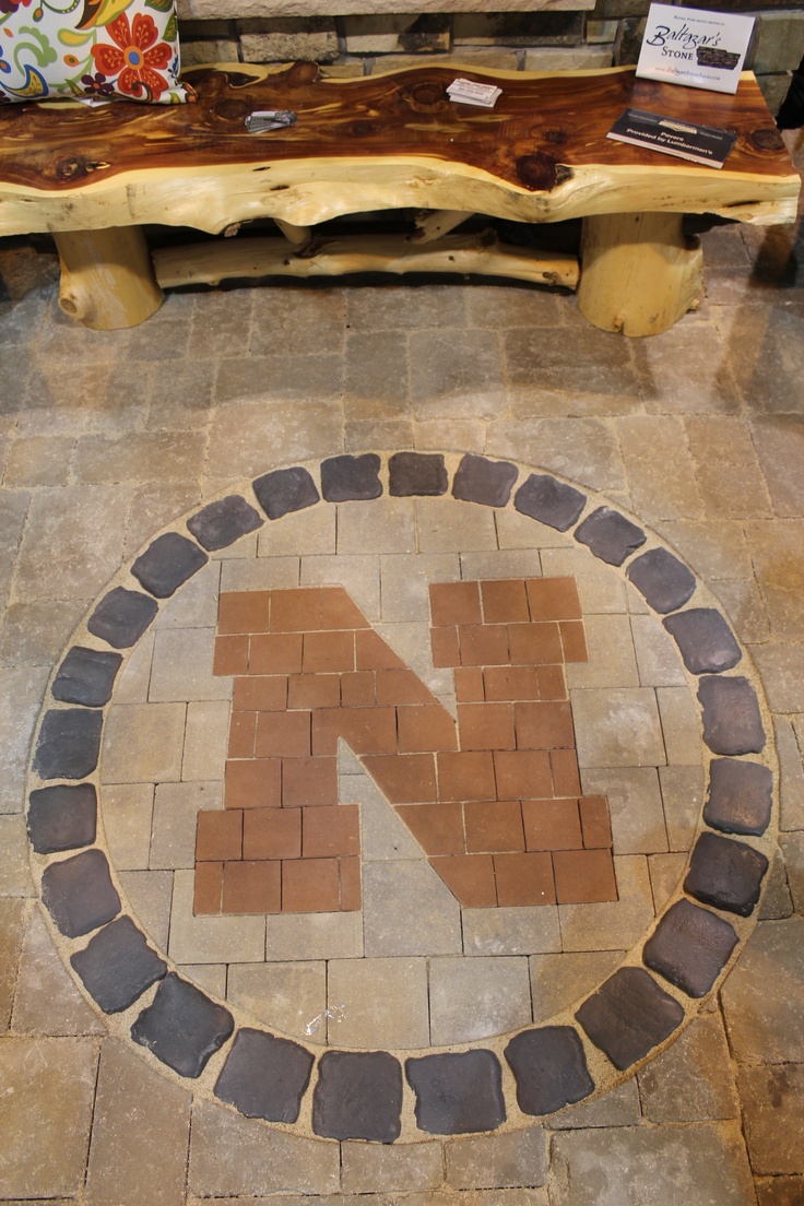 a bench made out of bricks with the letter n on it