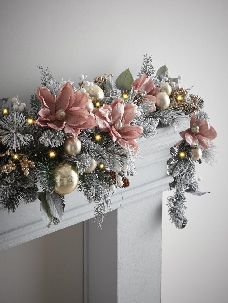 a fireplace mantel decorated for christmas with poinsettis and greenery on the mantle