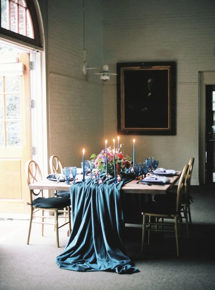 a dining room table with candles on it