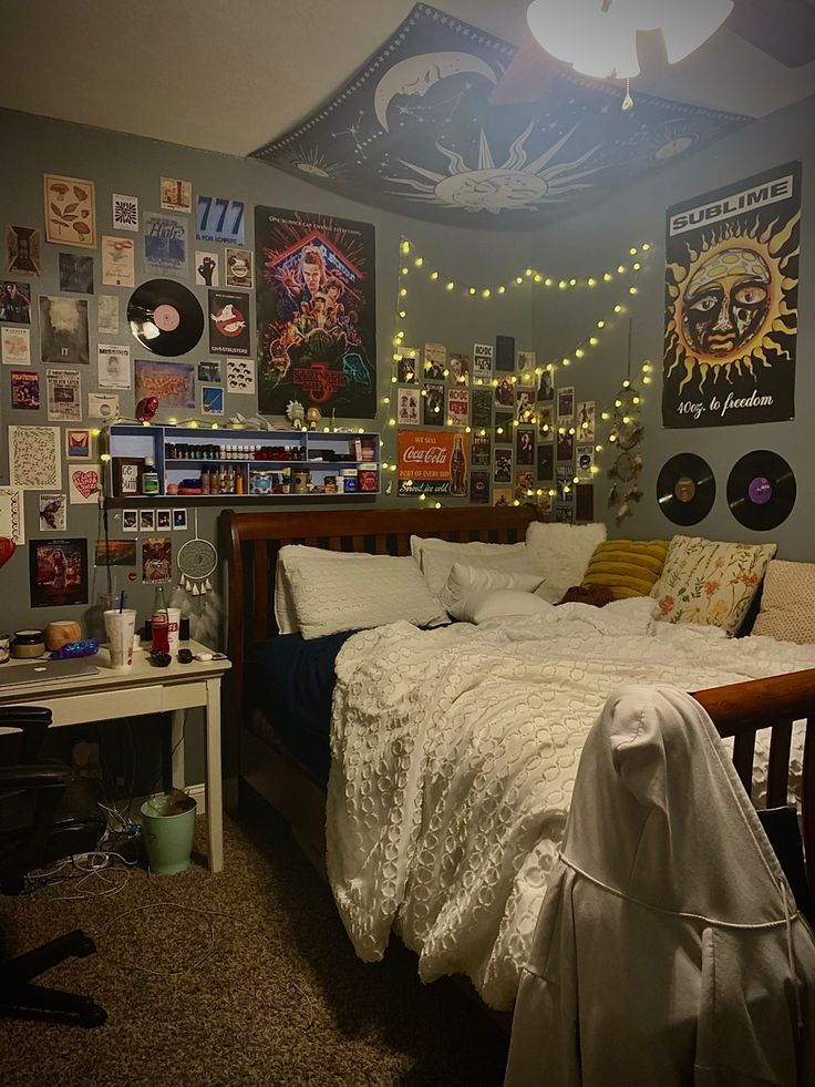 a bed room with a neatly made bed and lots of pictures on the wall