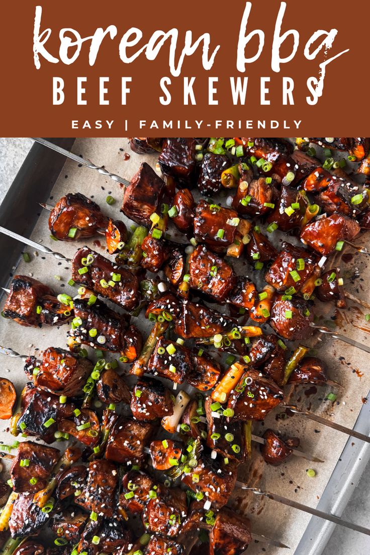 korean bbq beef skewers on a grill with sesame seeds and green onions