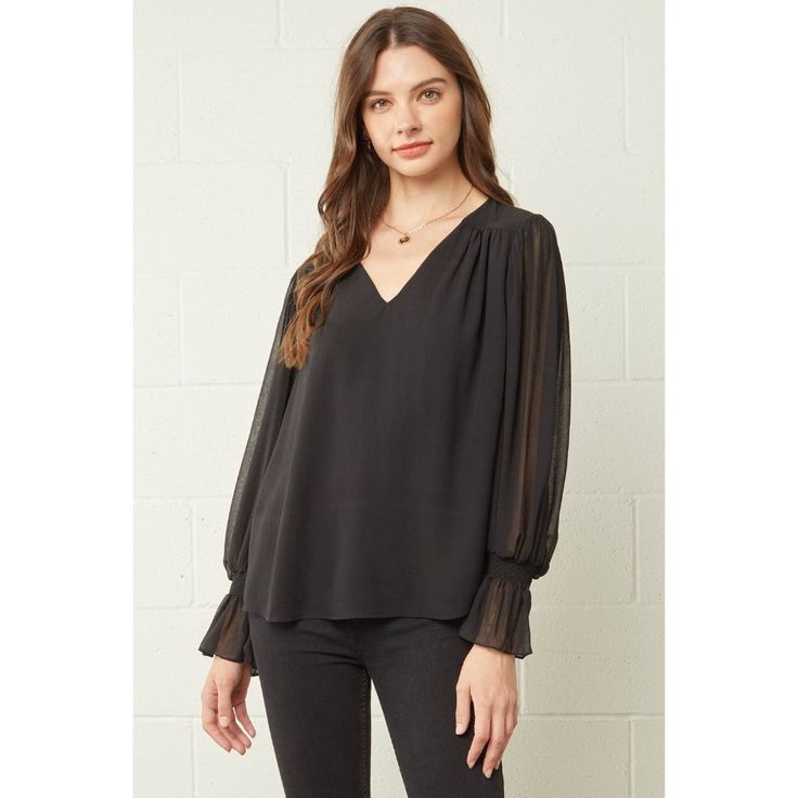 This Top Features A V-Neckline, Textured Fabric, Sheer Long Sleeves, Smocking At The Wrist, Gathered Detail At Shoulders, Is Fully Lined And An A-Line Silhouette. * Small Bust 38" Length 25" * Medium Bust 40" Length 25" * Large Bust 42" Length 25" * 100% Polyester * Model Is 5'10" And Wearing A Size Small * Hand Wash Or Dry Clean * Made In The Usa 16765 Black V-neck Top For Workwear In Fall, Black V-neck Top For Fall Workwear, Fall V-neck Top With Sheer Sleeves, Elegant V-neck Top With Sheer Sleeves, Sheer Sleeve V-neck Top For Night Out, Black V-neck Tops With Sheer Sleeves, Fall Sheer Sleeves V-neck Tops, Black V-neck Blouse For Layering, Black V-neck Blouse With Sheer Sleeves