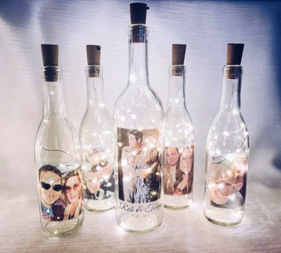 three bottles with pictures in them sitting next to each other