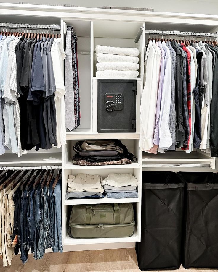 an organized closet with clothes and pants