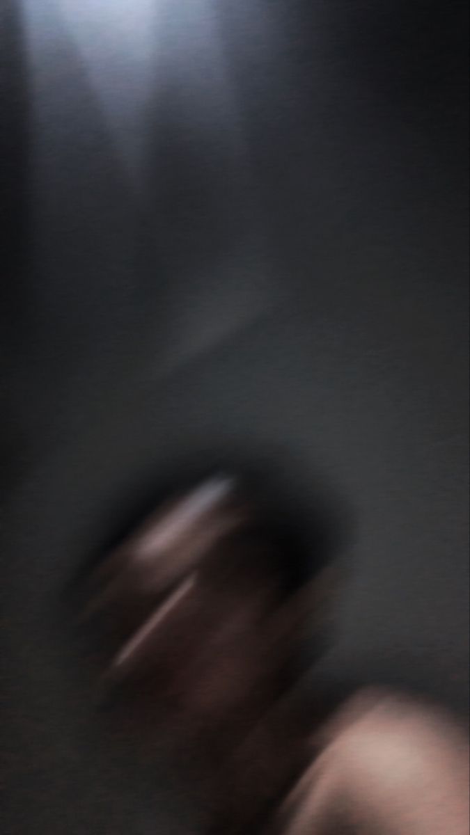 blurry image of a person walking in the dark