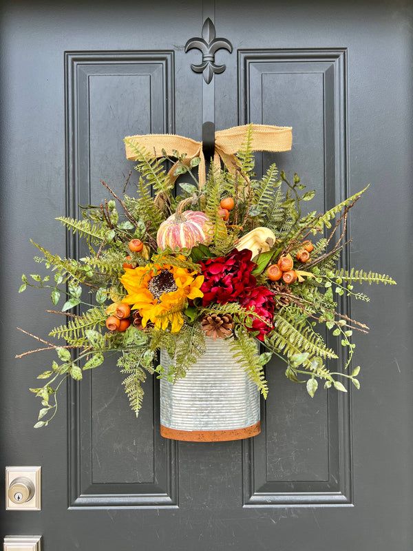 a vase filled with flowers sitting on top of a door