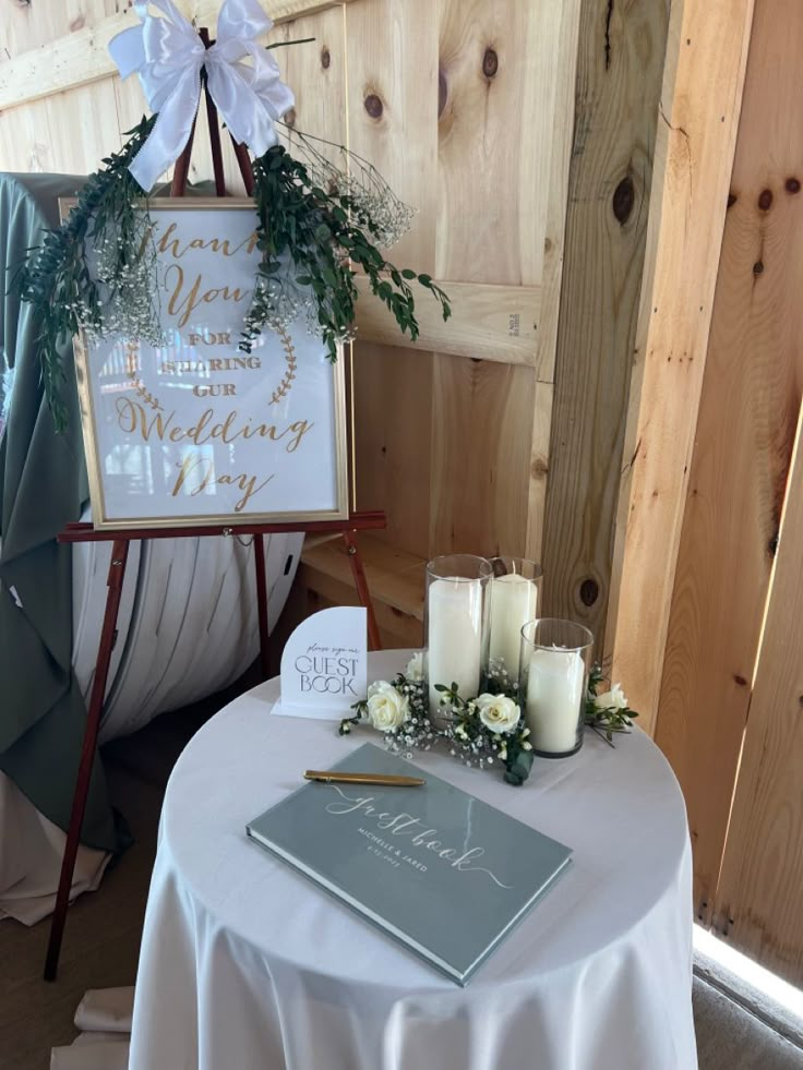 a wedding sign and candles on a table