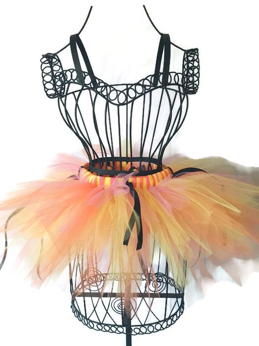 an orange and yellow tutu skirt on top of a mannequin headdress