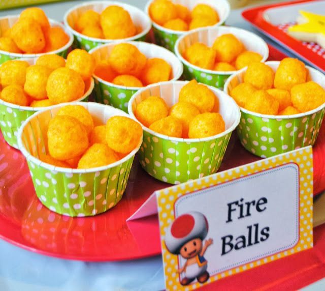 there are many small cups with food in them on the table and one has a sign that says fire balls