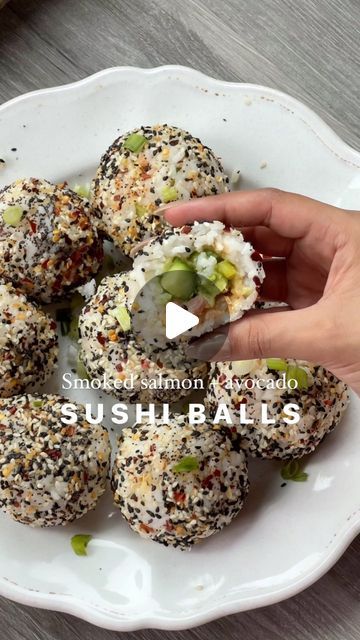 sushi balls on a white plate being held by someone's hand with the words sushiballs written below it