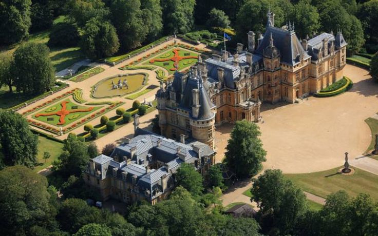 an aerial view of a large building surrounded by trees