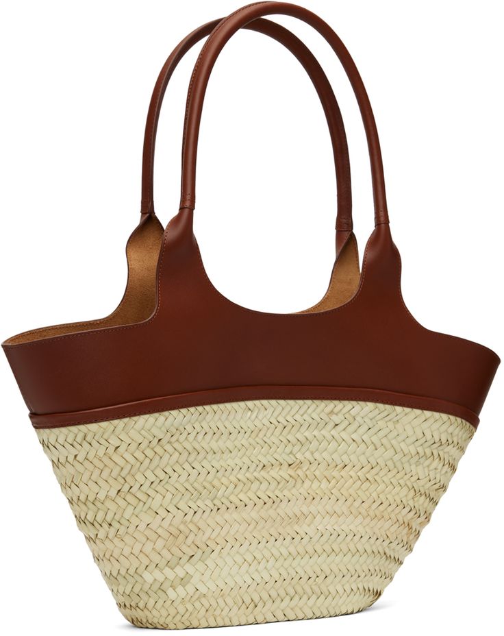 Woven straw tote in beige. · Buffed leather trim throughout · Twin carry handles · Logo stamp at face · Open throat · Unlined · H10.5 x W20 x D3.5 Supplier color: Noisette Designer Natural Straw Bag With Handles, Designer Natural Straw Bag, Designer Straw Basket Bag With Braided Handles, Classic Straw Bag With Leather Handles For Travel, Designer Natural Straw Bag With Bamboo Handle, Classic Straw Bag With Braided Handles, Classic Straw Bag With Braided Handles For Travel, Classic Natural Straw Bag For Travel, Classic Natural Straw Travel Bag