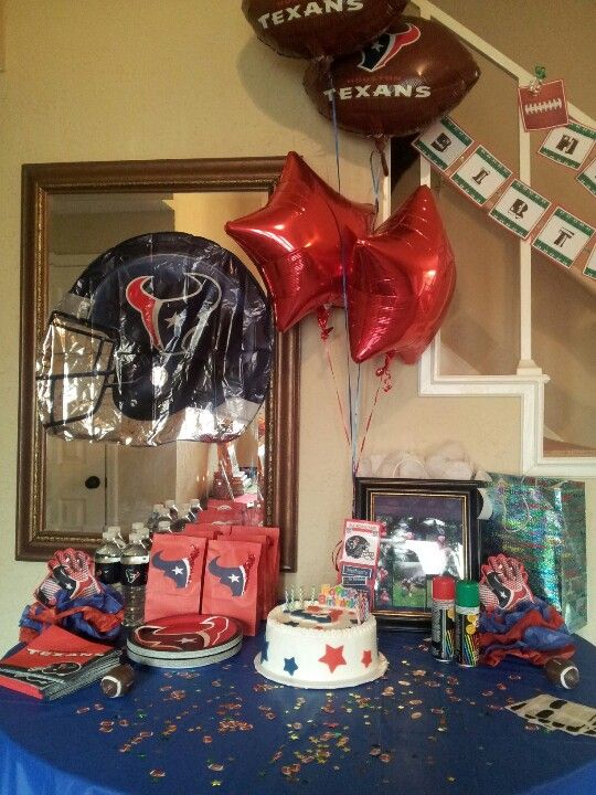 a table with balloons and decorations on it