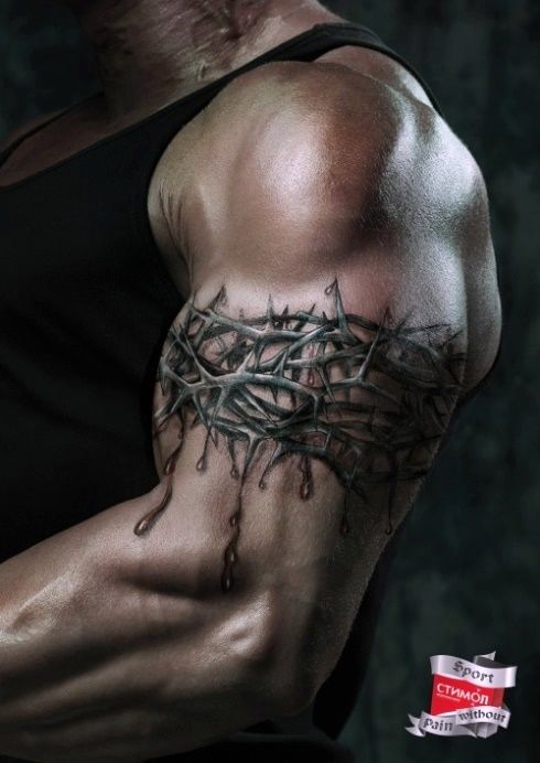 a man's arm covered in barbed wire