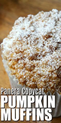 a cupcake covered in powdered sugar sitting on top of a wooden table with the title panera copycat pumpkin muffins