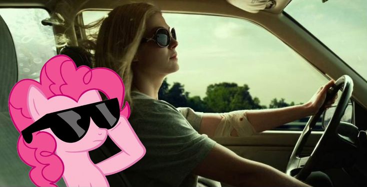 a woman driving a car with pinkie pie on the steering wheel and sunglasses over her eyes