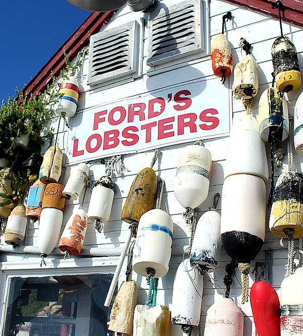 the front of a store with lots of lobsters hanging from it's walls