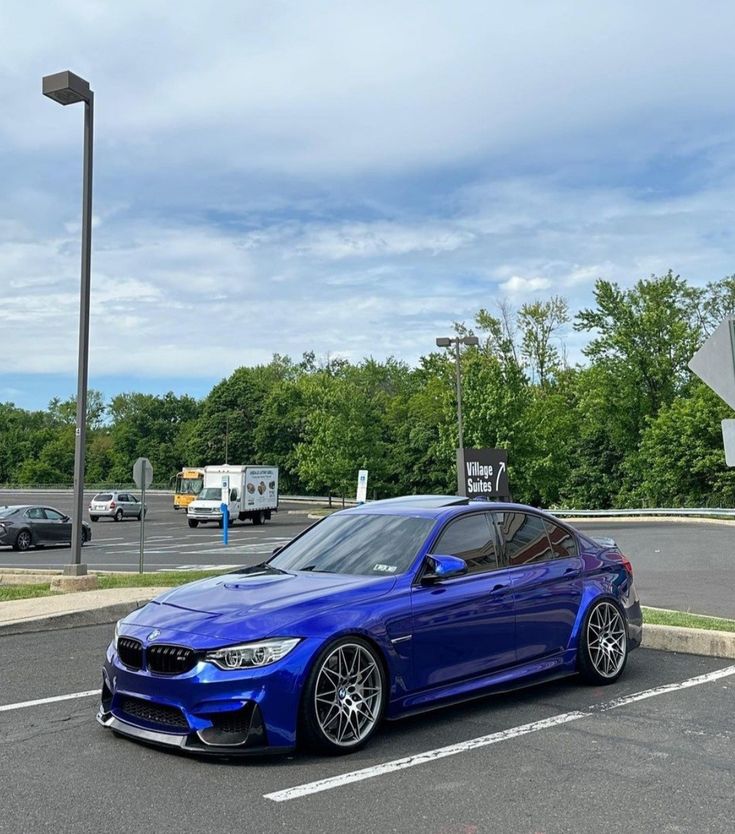 a blue car parked in a parking lot