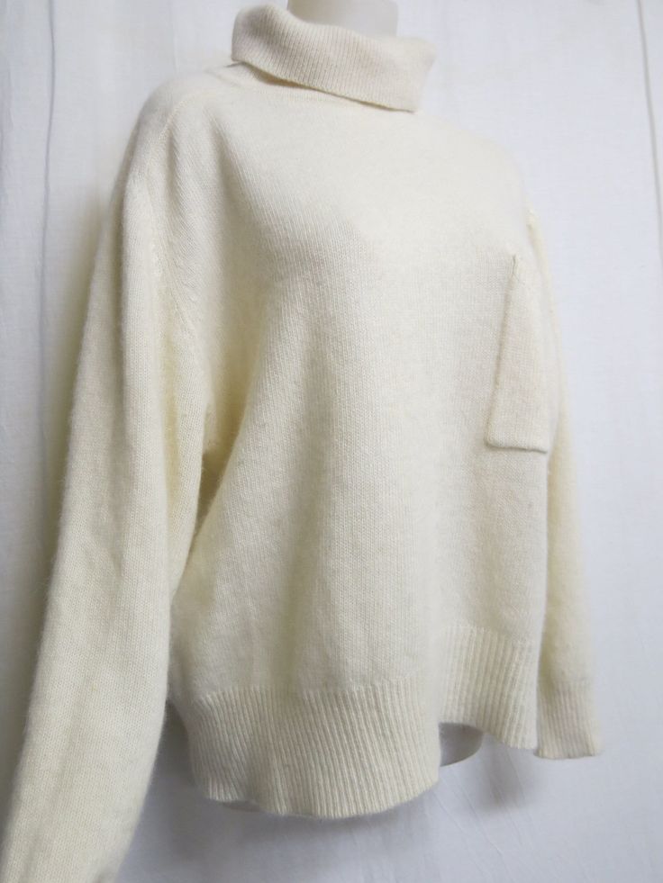 "Plush White Sweater 1990 Sarah Spencer Oversize and crazy soft! What an elegant twist on a classic white sweater! Chest pocket Lambs wool, angora and nylon blend  (NO shedding) Keep warm and make a fashion statement too! Excellent condition  all washed and ready to go Large 20\" Dropped shoulder 50\" chest. 44\"hip with stretch 19\" sleeve from under arm 26\" length Always wash in cold water and this will last a lifetime   https://www.etsy.com/shop/BelindasStyleShop" Classic White Soft Knit Sweater, Oversized White Sweater With Pockets, Winter Sweater With Side Pockets In Relaxed Fit, Relaxed Fit Sweater With Side Pockets For Winter, Classic White Sweater With Pockets, Winter Cream Tops With Pockets, Cream Winter Top With Pockets, Cream Sweater With Pockets For Fall, Winter Cream Top With Pockets