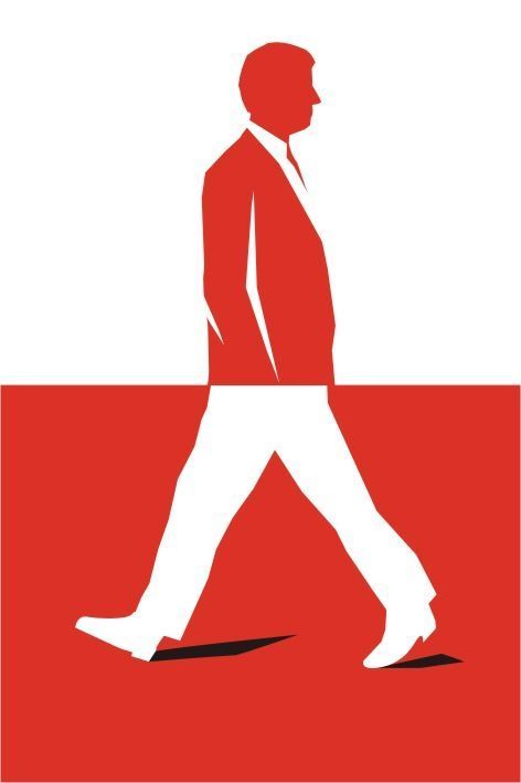 a man in a suit walking across a red and white square with the word, walk