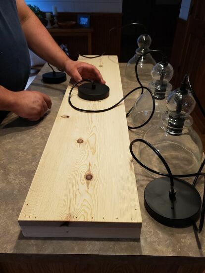 a person using a mouse on top of a piece of wood with wires attached to it