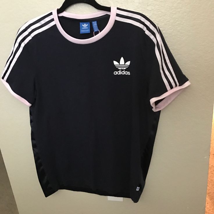 Adidas Size Medium Navy Blue With Light Pink Stripes Old School Logo Blue Tag T-Shirt 2 Materials The Back Is Sleek Front Is Jersey Knit New Without Tags ** Flawed** One Small Hole In The Seam At The Bottom Back In Photos Adidas Blue Tops With Three Stripes, Adidas Blue Three Stripes Top, Blue Adidas Tops With Three Stripes, Adidas Blue Tops With Three Stripes Branding, Blue Adidas Tops With Three Stripes Branding, Spring Adidas Athleisure T-shirt, Adidas Athleisure T-shirt For Spring, Blue Three Stripes Tops For Summer, Adidas Pink Short Sleeve T-shirt