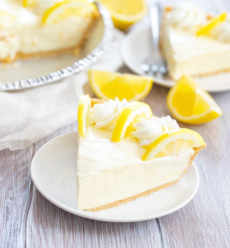 a slice of lemon pie on a plate with two slices cut out and ready to be eaten