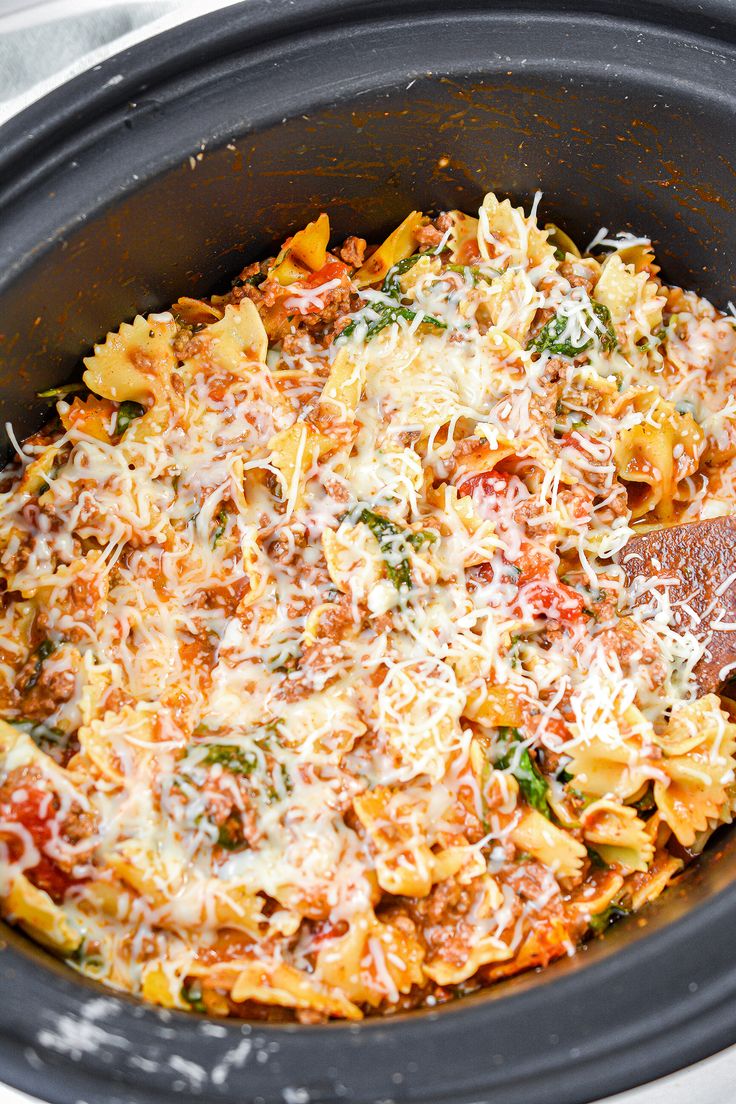 a crock pot filled with pasta and cheese