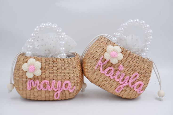 two small baskets with flowers and the word kayya on them are sitting next to each other