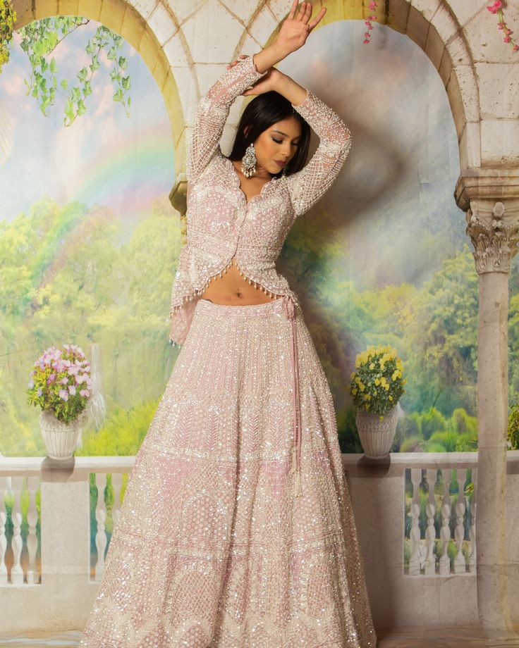 Indulge in the splendor and elegance of Aura Lehenga specially tailored for weddings and other events. Shine with intricate pearl and stone work that gives elegance and charm. A master stroke that makes you look like a view to behold. Color - Fabric & Work Style - - Silk blouse: mirror, pearl, stone, embroidery work. - Chiffon lehenga Saree: mirror, pearl, stone, embroidery work. - Attached dupatta Semi-stitched Embellished Sharara For Wedding, Hand Embellished Traditional Wear For Eid Wedding, Eid Wedding Traditional Wear Hand Embellished, Eid Wedding Hand Embellished Traditional Wear, Cutdana Georgette Sets For Wedding, Wedding Georgette Sets With Cutdana, Traditional Kundan Palazzo Set For Wedding, Wedding Chandbali Palazzo Set With Cutdana, Traditional Palazzo Set With Pearl Embroidery For Diwali