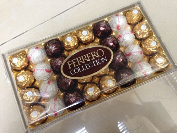 a box filled with assorted chocolates on top of a table