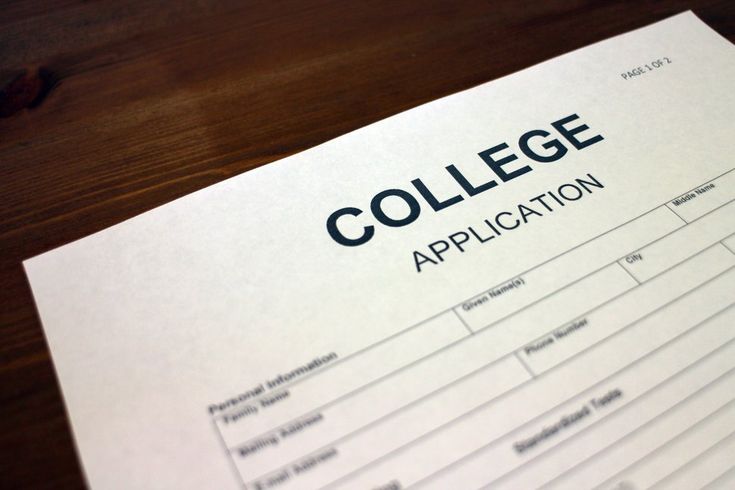 a college application sitting on top of a wooden table