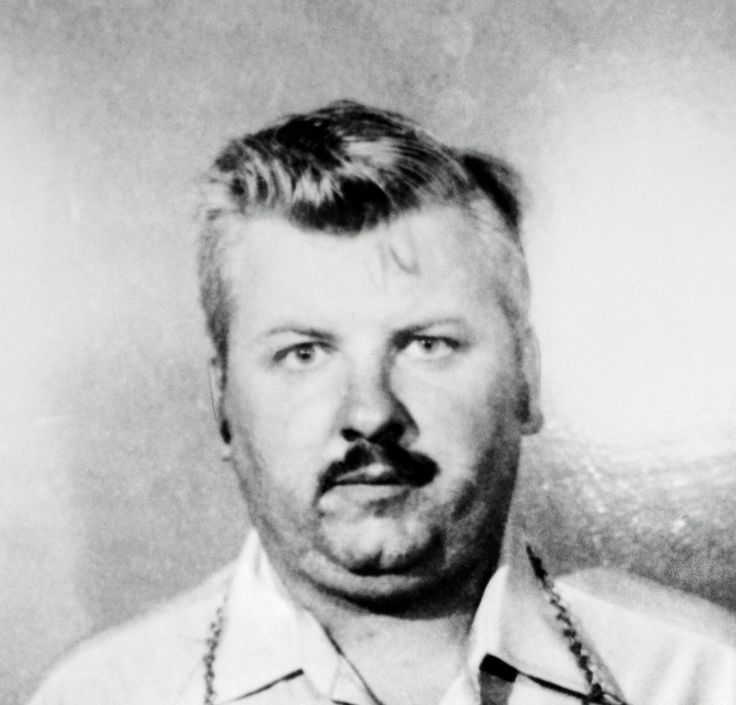 an old black and white photo of a man with a mustache wearing a shirt and tie