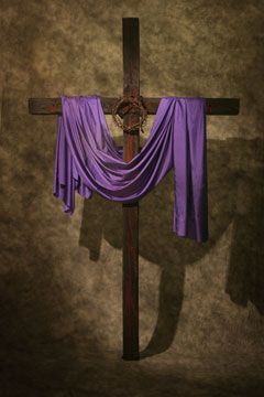 a cross with purple cloth draped around it