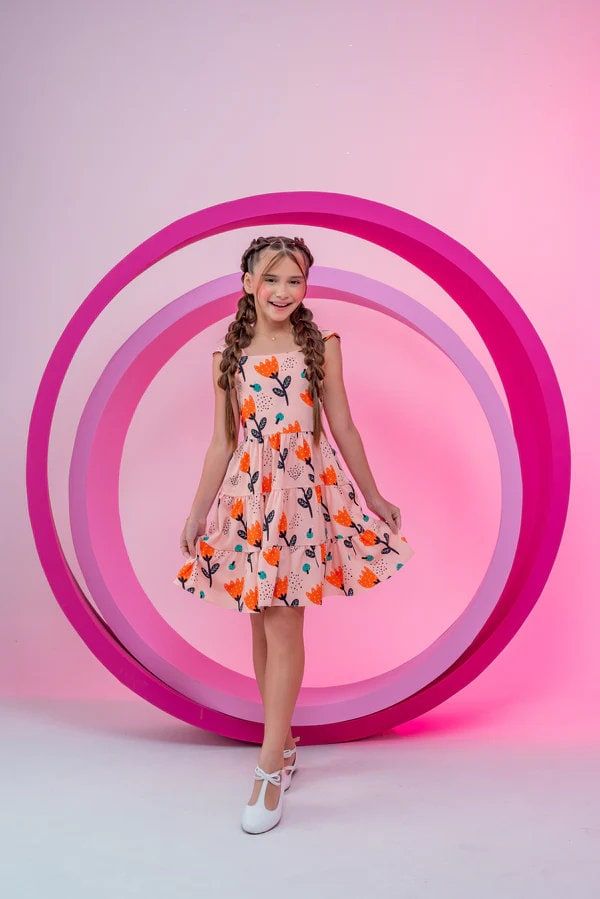 This beautiful salmon floral dress for girls, ages 4-8, is a perfect blend of comfort and charm. Featuring a playful floral print, a delicate tie at the back, and a ruffled hem, this dress is ideal for any occasion, whether it's a casual day out or a special event. Made from soft, high-quality fabric, it ensures your little one stays comfortable and stylish all day long. Casual Floral Print Twirl Dress For Spring, Playful Orange Dress For Spring, Playful Pink Floral Print Twirl Dress, Playful Pink Twirl Dress With Floral Print, Playful Orange Spring Dress, Casual Pink Twirl Dress For Spring, Playful Peach Summer Dress, Playful Peach Spring Dress, Dress For Girls