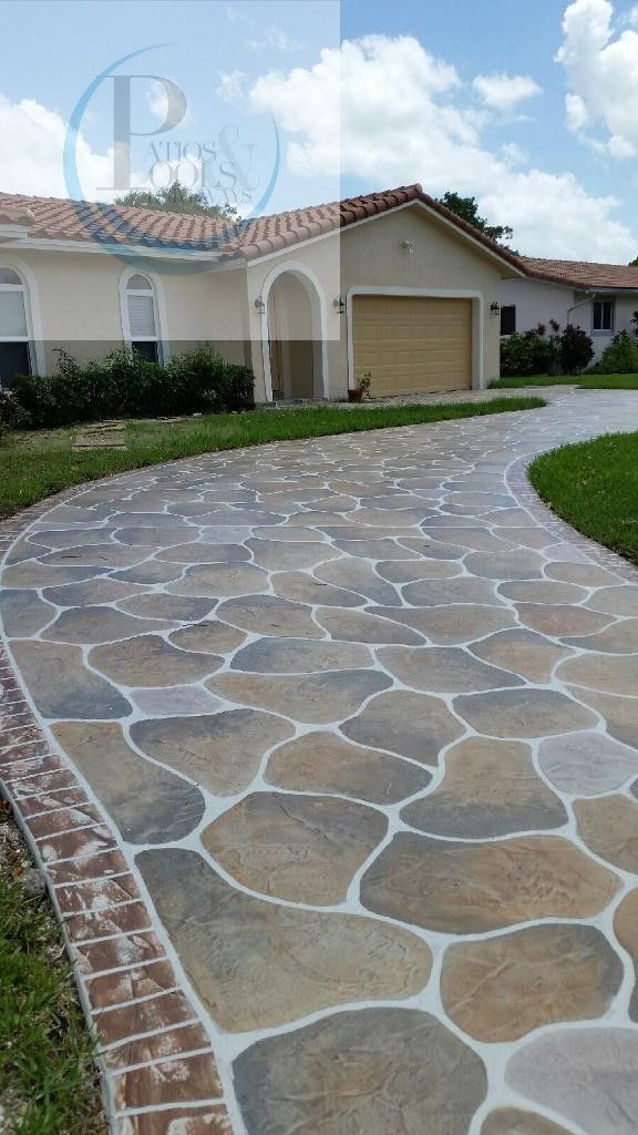 a stone walkway in front of a house