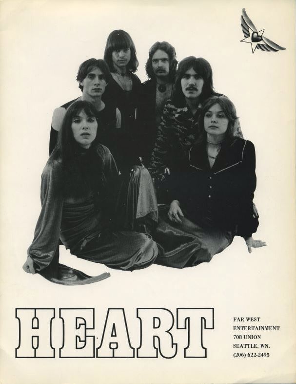 an old concert poster with the band heart on it's back cover, and two men sitting in front of them