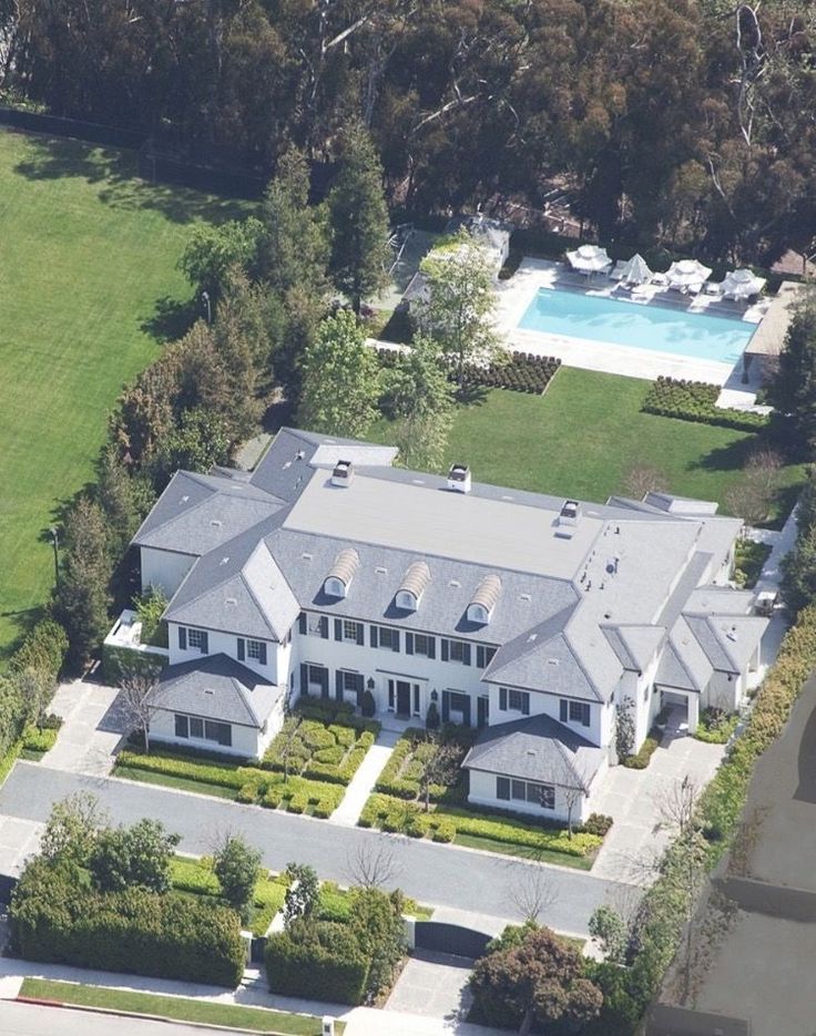 an aerial view of a large white house