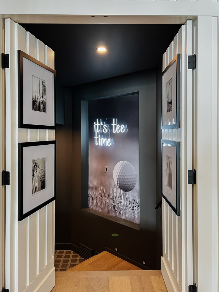 an open door leading to a room with pictures on the wall and a golf ball in it