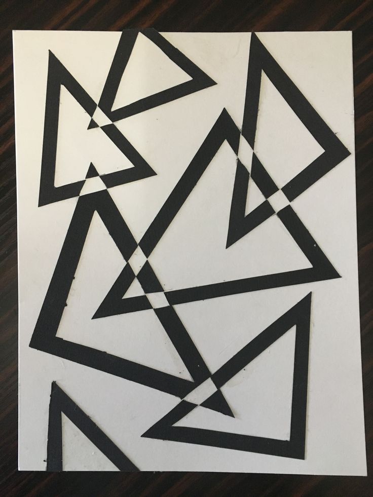 some black and white shapes are on a piece of paper that has been cut into smaller triangles