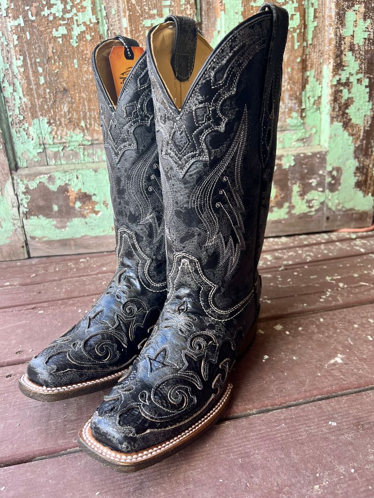 The perfect black boot with that little bit of attitude. This square toe boot features a distressed black leather overlay with a black snakeskin inlay. Sassy without being over the top! Features: Genuine Leather Square Toe 11.5" Shaft 1.5" Heel Circumference: 13" Cushioned Insole Leather Outsole ﻿Measurements for this boot were taken from a size 9M. Please note that measurements may vary by size. Black Womens Cowboy Boots, Womens Black Cowboy Boots, Square Toe Boots Cowgirl, Cowboy Boots Aesthetic, Black Square Toe Boots, Cowgirl Things, Wedding Cowboy Boots, Cowgirl Boots Square Toed, Black Western Boots