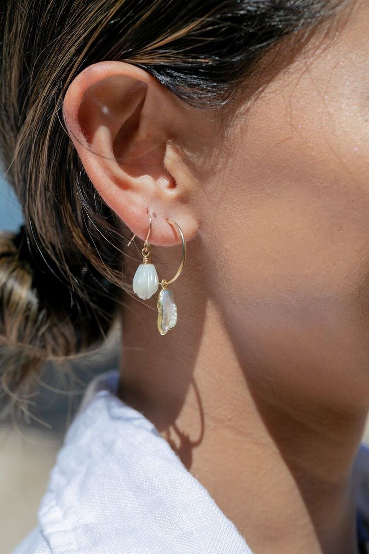 These simple gold pikake earrings exude Hawaii's natural beauty. These gold earrings feature hand carved mother of pearl pikake flowers reminiscent of Hawai'i's flower leis. They are perfect solo or teamed with our other earrings. ✦ DETAILS ✦ ✧ Name: Kamakana (KA ma KA na) - the gift. ✧ 14kt Gold Filled w/carved mother of pearl shell Pikake flowers. ✧ 1 inch drop length. ✧ All Ke Aloha Jewelry pieces come packaged thoughtfully, beautifully, and ready for gift giving. ✧ Unless otherwise noted in Hawaii Jewelry, Gemstone Hoop Earrings, Biwa Pearls, White Pearl Earring, Seashell Jewelry, Mother Of Pearl Earrings, Gold Pearl Earrings, Pearl Hoop Earrings, Shell Jewelry