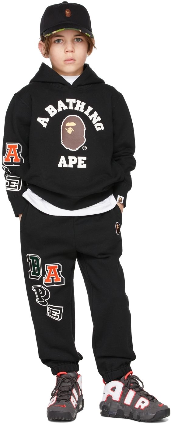 Straight-leg cotton fleece lounge pants in black featuring embroidered logo patches in multicolor. Text printed in white at leg. · Mid-rise · Three-pocket styling · Rib knit elasticized waistband and cuffs · Machine wash Model measures 49 / 124.5 cm tall and wears size 120. Supplier color: Black BAPE Size: child's height 90: 33.5-37.5 / 85-95 cm 100: 37.5-41.5 / 95-105 cm 110: 41.5-45.5 / 105-115 cm 120: 45.5-49 / 115-125 cm 130: 49-53 / 125-135 cm 140: 53-57 / 135-145 cm 150: 57-61 / 145-155 cm Bape Pants Jeans, Bape Varsity Jacket, Bape Star Hoodie, Black Bape Hoodie, Bape Kids, Bape Hoodie, Kids Black, Pants Straight, Cotton Fleece