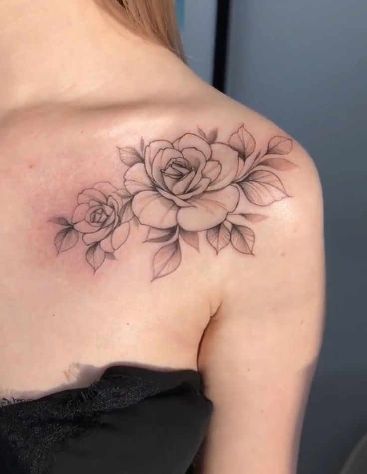 a woman with a rose tattoo on her shoulder