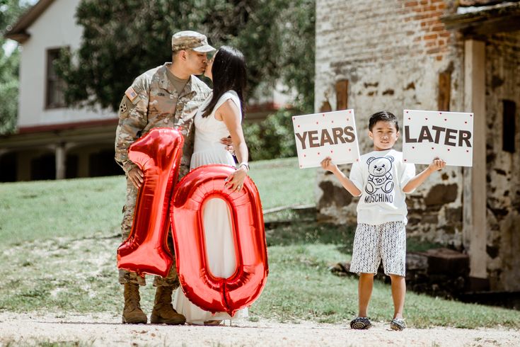 a man and woman standing next to each other holding up signs that say 50 years later