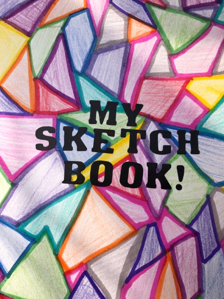 a drawing with the words my sketch book written on it in front of colored pencils