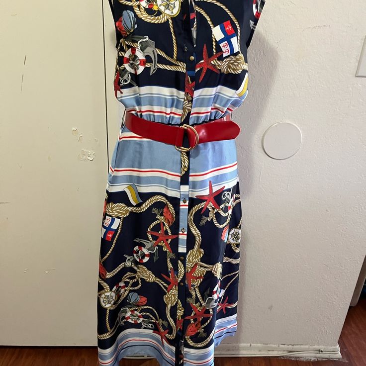 This Beautiful Nautical Dress Is Sleeveless, Buttons Down The Front, Is Unlined, Has Elastic In The Waist Front And Back, And Has A Red Belt. The Bust Is 36, The Waist.Is 26, The Hip Is 42, And The Length Is 46. This Dress Is New With Tags And Has No Blemishes. Beach Sleeveless Midi Dress Lined, Beach Midi Sleeveless Lined Dress, Nautical Spring Vacation Dresses, Blue Nautical Spring Dresses, Nautical Sleeveless Dresses For The Beach, Nautical Sleeveless Beach Dress, Navy Midi Dress For Summer Vacation, Blue Nautical Dress For Summer, Navy Marine Style Summer Dress