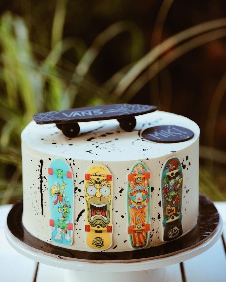 a cake decorated with skateboards on top of a white plate and black trimmings